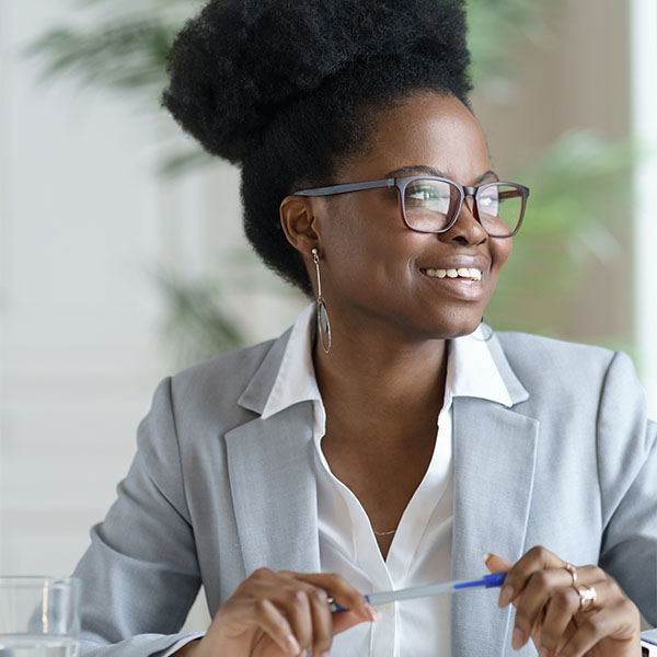 Woman smiling with a pen